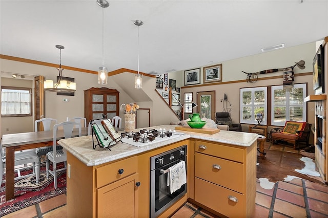 kitchen featuring white gas stovetop, open floor plan, a center island, oven, and light countertops