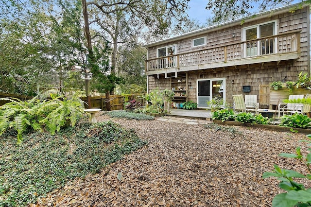 back of house with a patio, fence, and a balcony