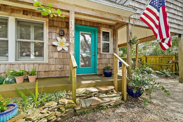 view of exterior entry with fence