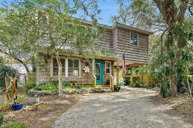 view of front of home with driveway and fence