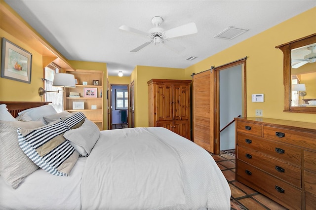 bedroom with tile patterned flooring, visible vents, and a ceiling fan