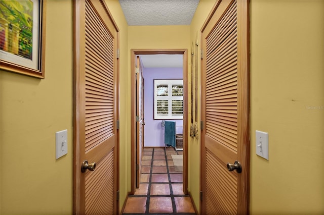 corridor featuring a textured ceiling