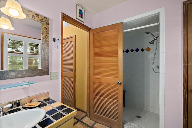 bathroom with a sink and a shower stall