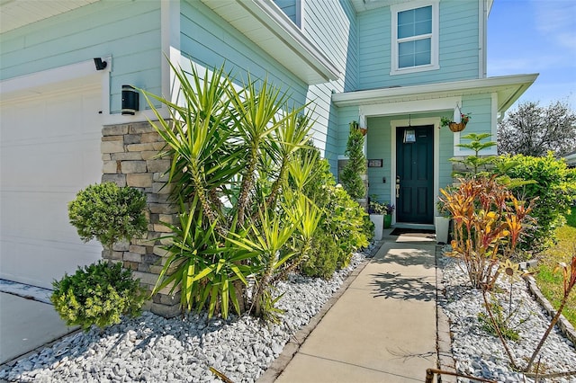 view of exterior entry with a garage