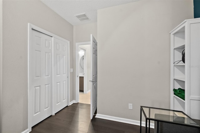 home office featuring baseboards, visible vents, and dark wood finished floors