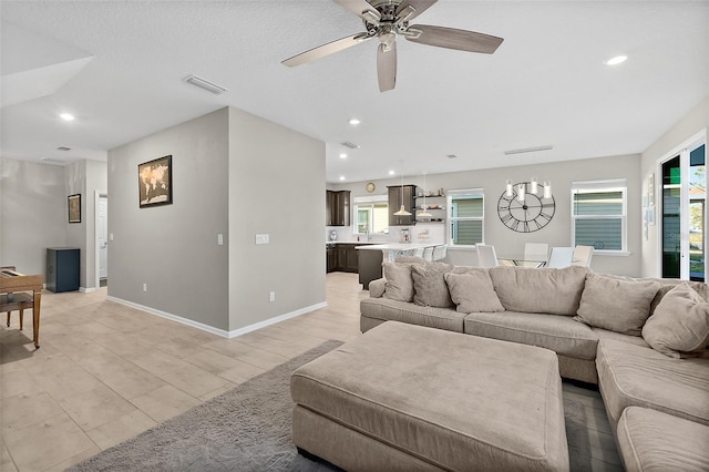 living area featuring a ceiling fan, recessed lighting, visible vents, and baseboards