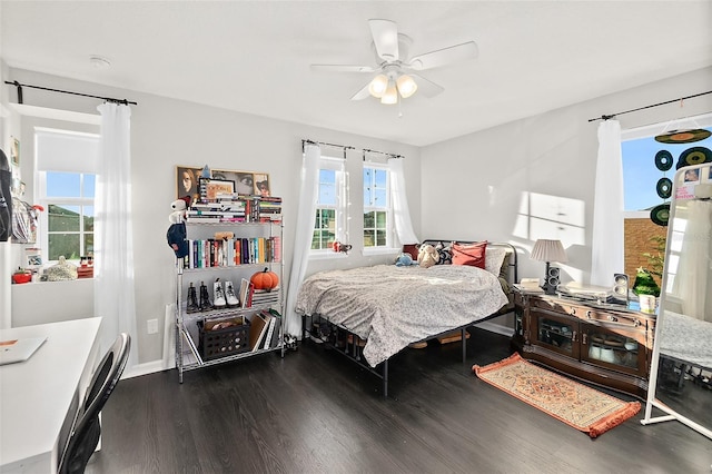 bedroom featuring ceiling fan, baseboards, and wood finished floors