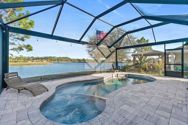 view of pool with a pool with connected hot tub, a lanai, a water view, and a patio