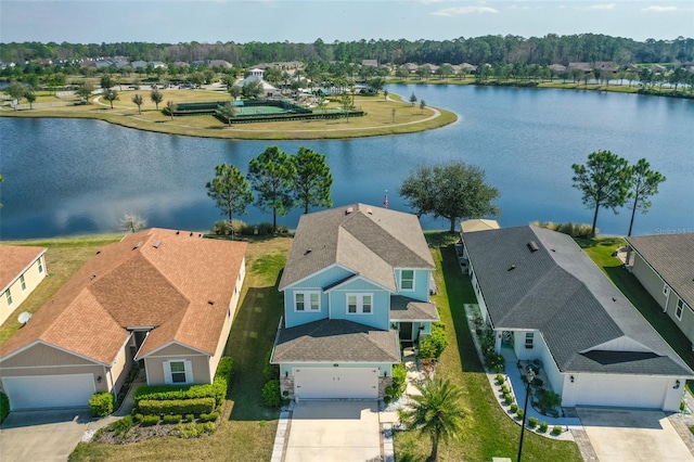 birds eye view of property with a water view and a residential view