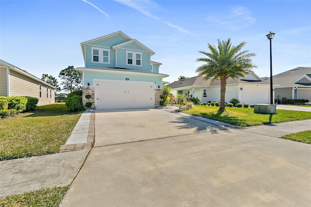 view of front of house with an attached garage, concrete driveway, stone siding, and a front yard