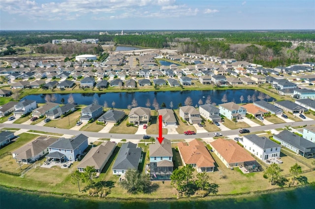 drone / aerial view with a water view and a residential view