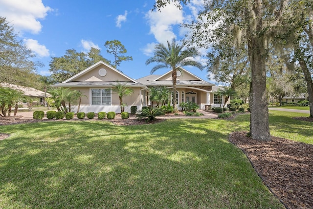 view of front of home featuring a front lawn and stucco siding