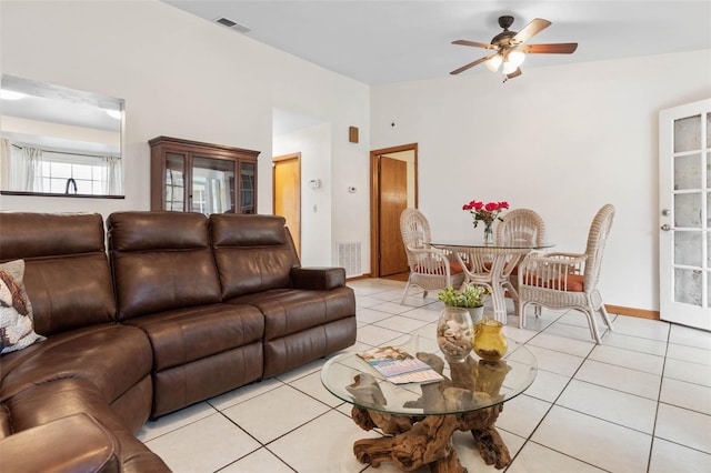 living room with lofted ceiling, visible vents, ceiling fan, and light tile patterned floors