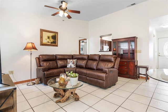 living room featuring light tile patterned floors, ceiling fan, and visible vents