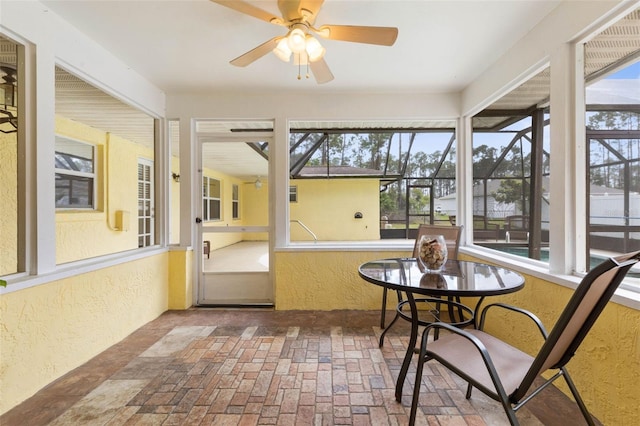 sunroom featuring ceiling fan