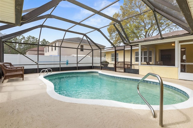 view of swimming pool featuring a lanai, fence, a fenced in pool, and a patio