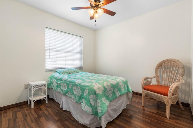 bedroom featuring ceiling fan, baseboards, and wood finished floors