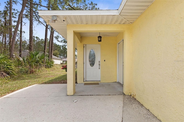 doorway to property with stucco siding