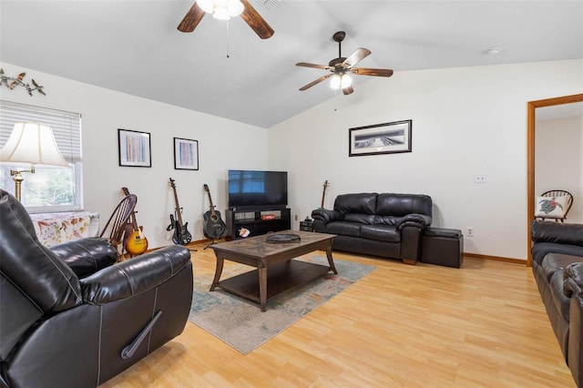 living room with lofted ceiling, light wood-style flooring, baseboards, and a ceiling fan