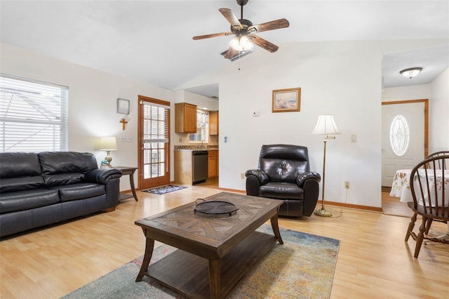 living room featuring light wood-type flooring, ceiling fan, baseboards, and lofted ceiling