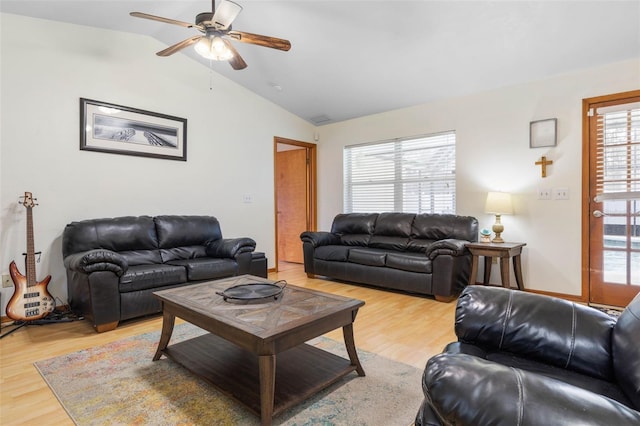 living area with lofted ceiling, light wood-style flooring, and a ceiling fan