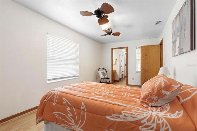 bedroom featuring visible vents, ceiling fan, baseboards, and wood finished floors