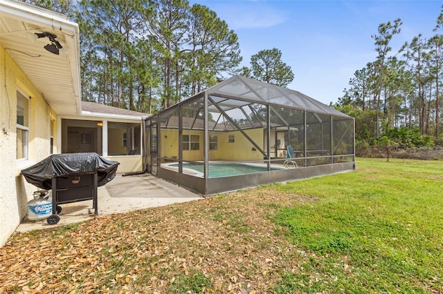 exterior space featuring a yard, a patio area, and glass enclosure