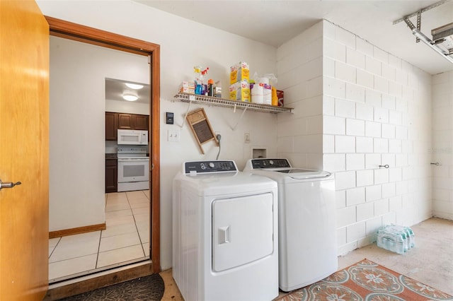 washroom with laundry area, independent washer and dryer, and light tile patterned floors