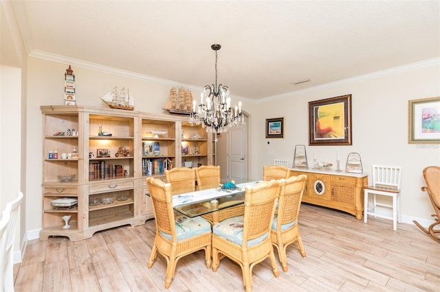 dining space with an inviting chandelier, light wood-style flooring, and crown molding