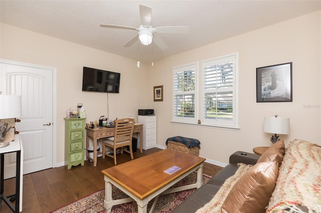 living room with baseboards, a textured ceiling, dark wood-type flooring, and ceiling fan