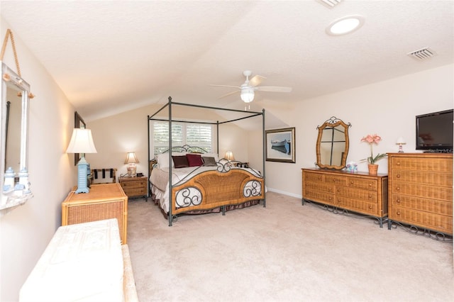 bedroom featuring visible vents, ceiling fan, lofted ceiling, carpet floors, and a textured ceiling