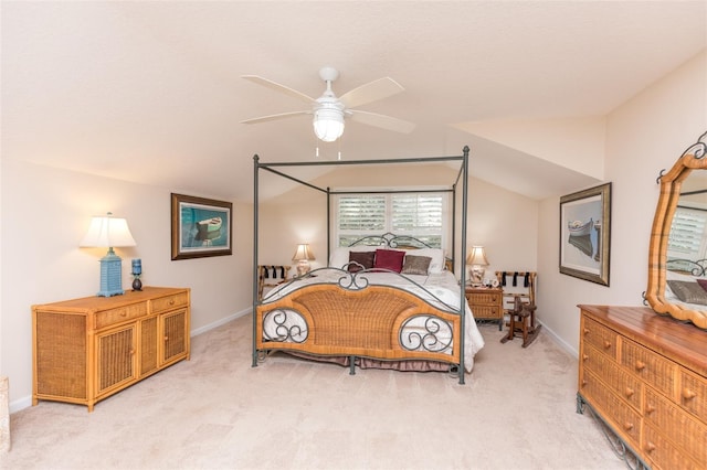 bedroom featuring light colored carpet, baseboards, lofted ceiling, and ceiling fan