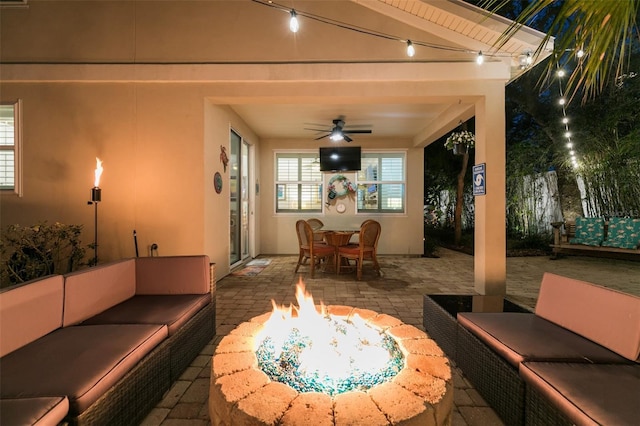 view of patio / terrace with outdoor dining space, an outdoor living space with a fire pit, and ceiling fan