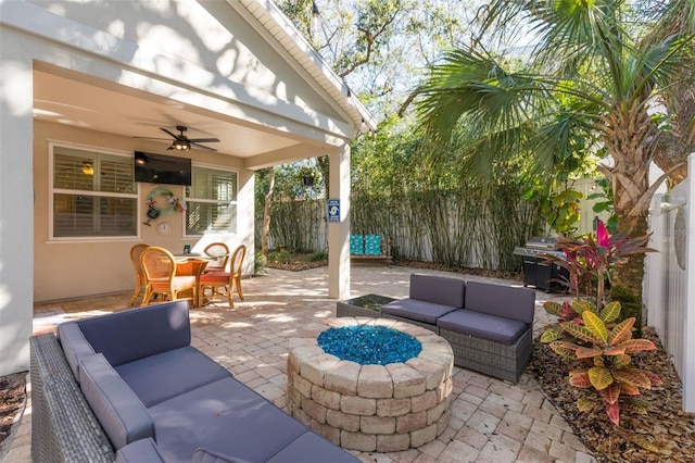 view of patio featuring a ceiling fan, fence, outdoor dining area, grilling area, and an outdoor hangout area