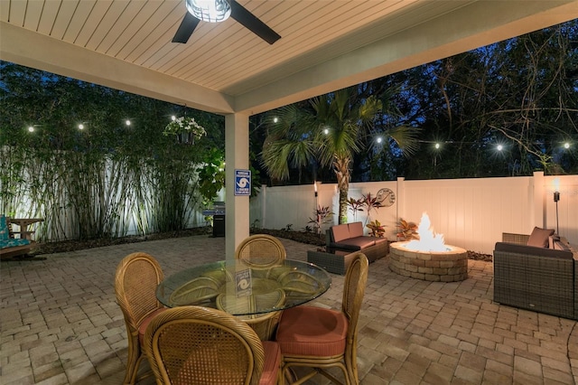 view of patio / terrace featuring a ceiling fan, area for grilling, a fire pit, and a fenced backyard