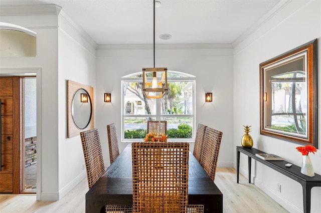 dining area featuring baseboards, light wood-style flooring, ornamental molding, and a wealth of natural light