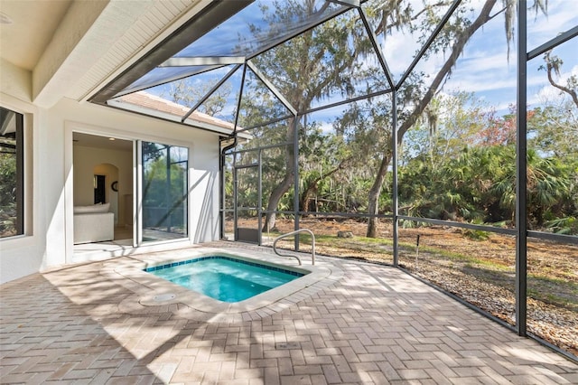 view of swimming pool featuring a patio, a lanai, and a jacuzzi