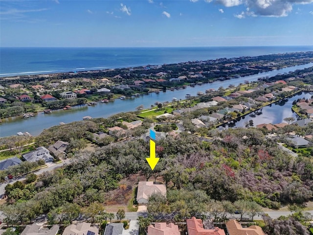 drone / aerial view with a water view and a residential view