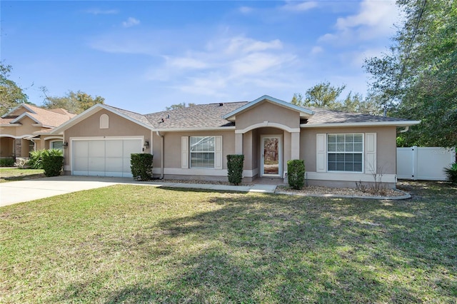 single story home featuring stucco siding, an attached garage, a front yard, fence, and driveway