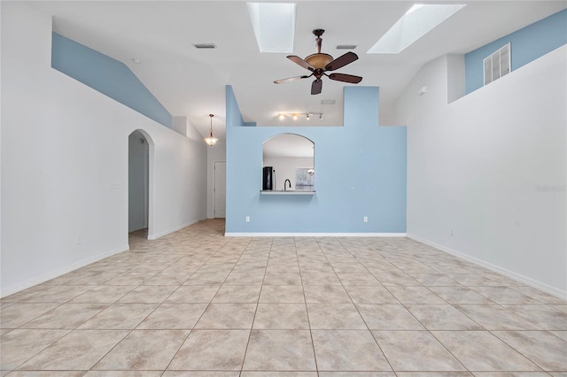 unfurnished living room featuring high vaulted ceiling, visible vents, arched walkways, and a ceiling fan