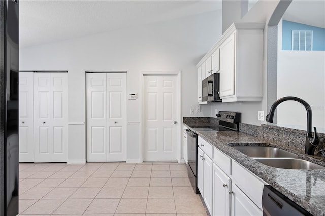 kitchen with light tile patterned floors, a sink, white cabinets, vaulted ceiling, and black appliances