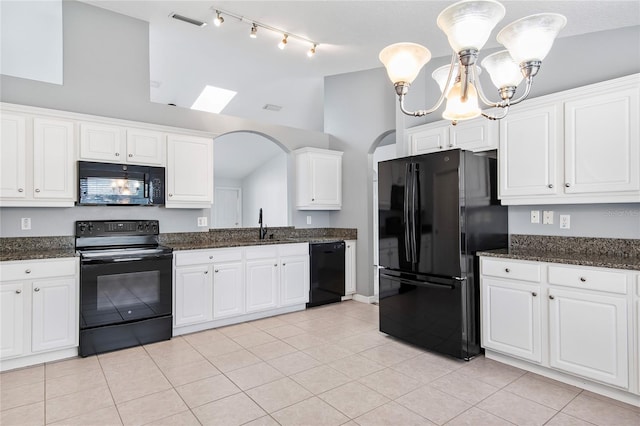 kitchen featuring a notable chandelier, visible vents, white cabinets, vaulted ceiling, and black appliances