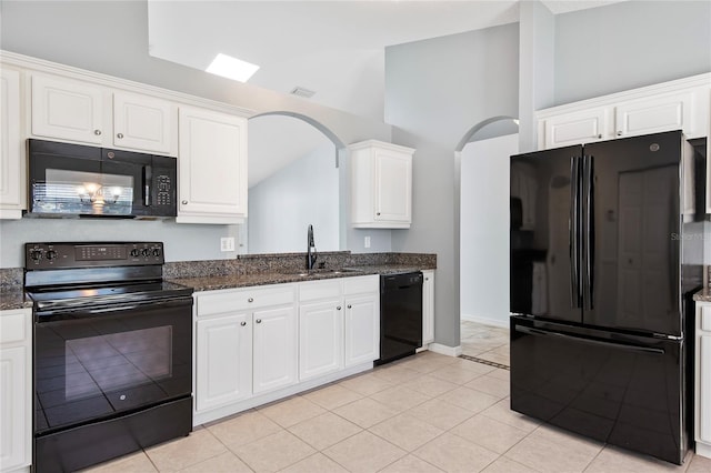 kitchen featuring visible vents, black appliances, a sink, and white cabinetry