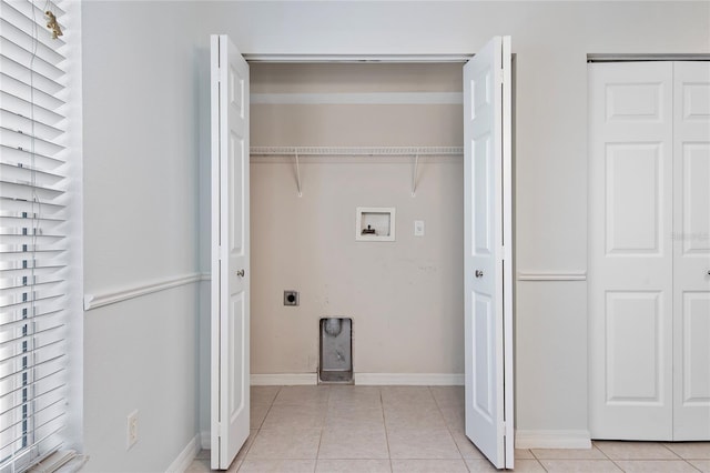 laundry room with laundry area, baseboards, hookup for an electric dryer, washer hookup, and light tile patterned flooring