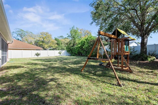 view of yard featuring a fenced backyard and a playground