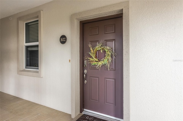 view of exterior entry featuring stucco siding