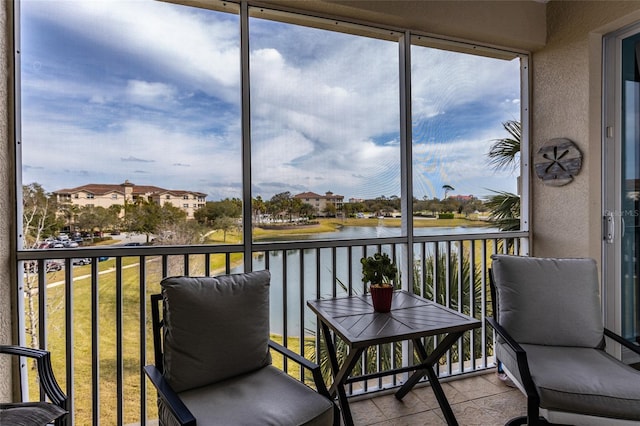 sunroom / solarium with a water view