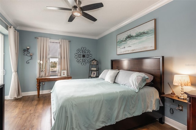 bedroom featuring ornamental molding, wood finished floors, a ceiling fan, and baseboards