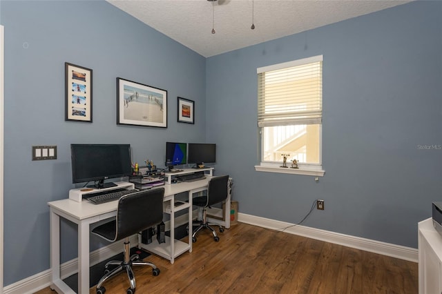 office area featuring a textured ceiling, baseboards, and wood finished floors