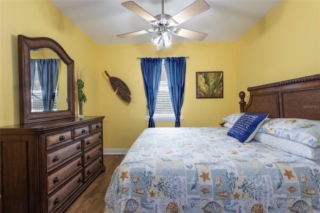 bedroom with dark wood-style floors, baseboards, and a ceiling fan